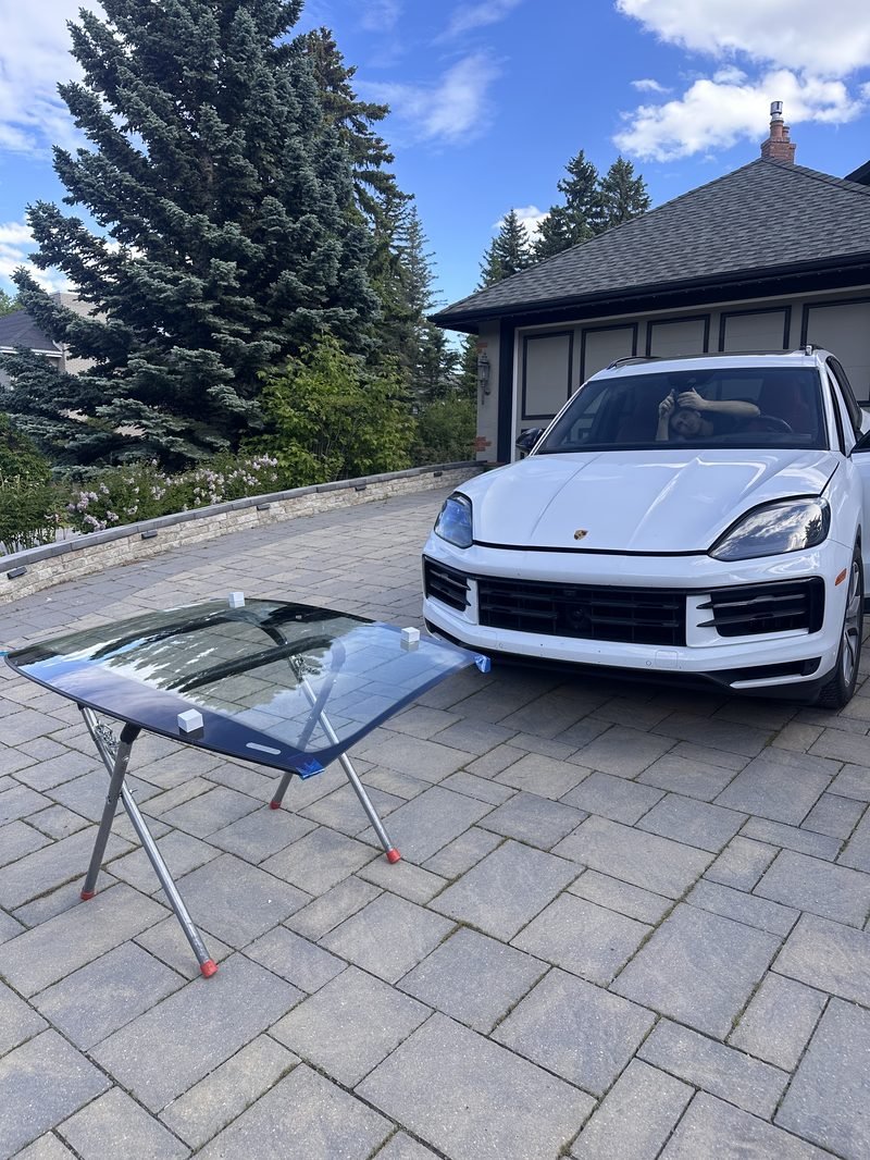 Porsche Cayenne. New windshield on the stand, ready to go in. Driveway job.